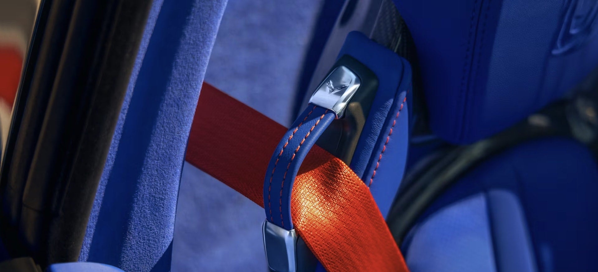 2027 Chevrolet Corvette Grand Sport seatbelt buckle closeup with Corvette logo and red belt