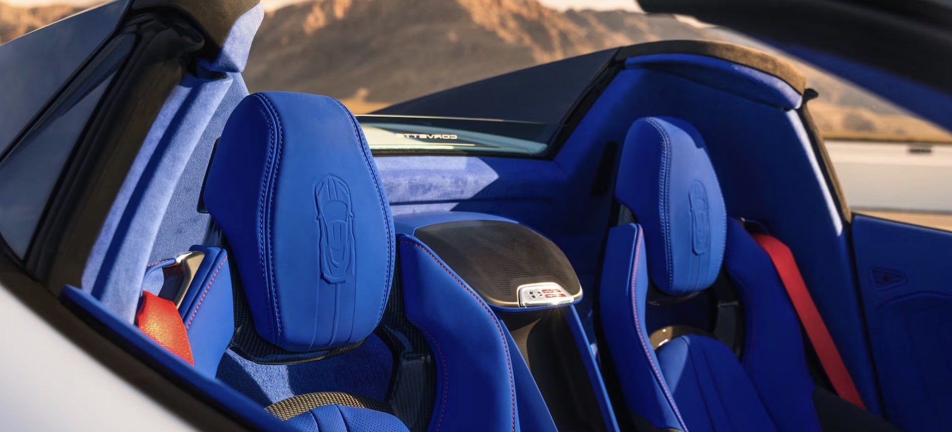 2027 Chevrolet Corvette Grand Sport interior with blue suede seats and embossed Corvette silhouette headrests