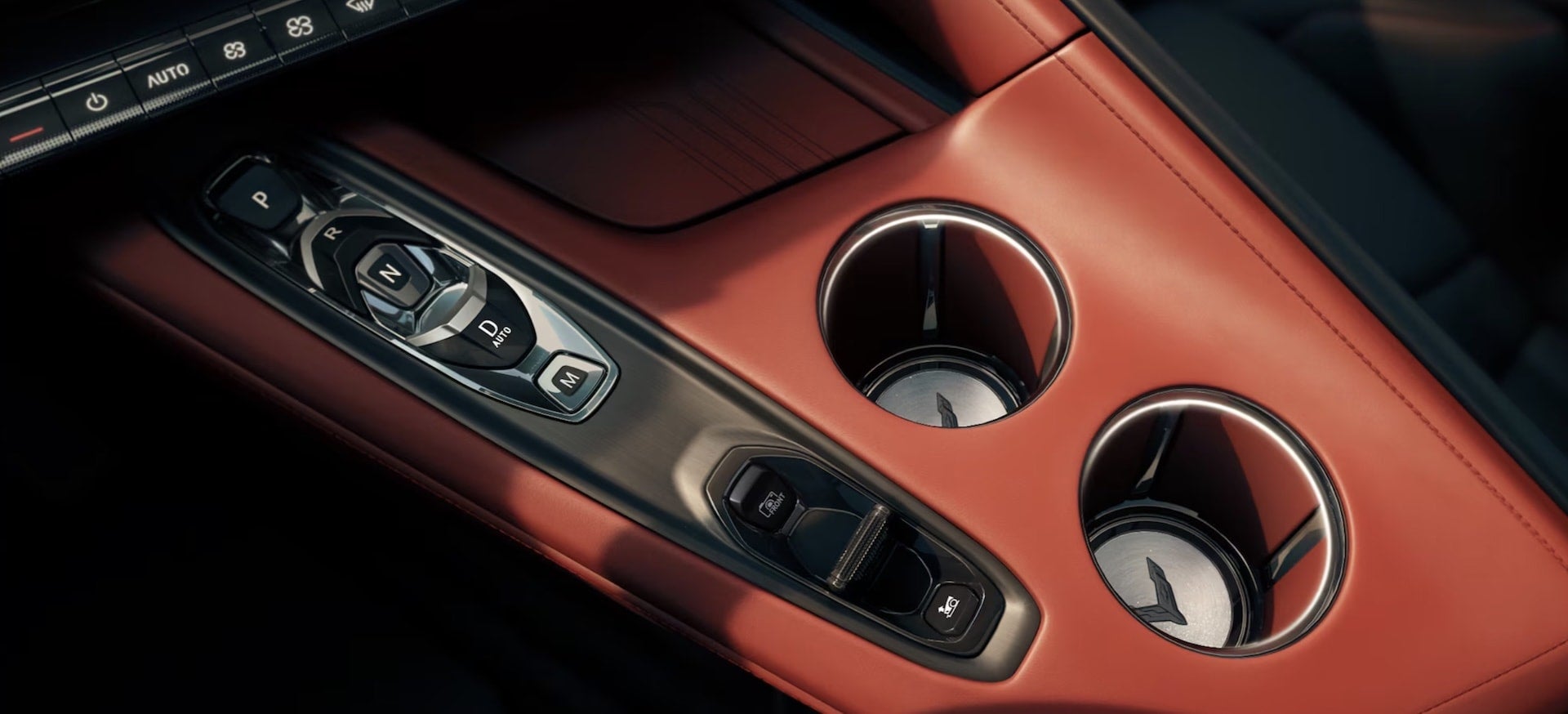2027 Chevrolet Corvette Grand Sport center console with gear selector and cupholders in red leather