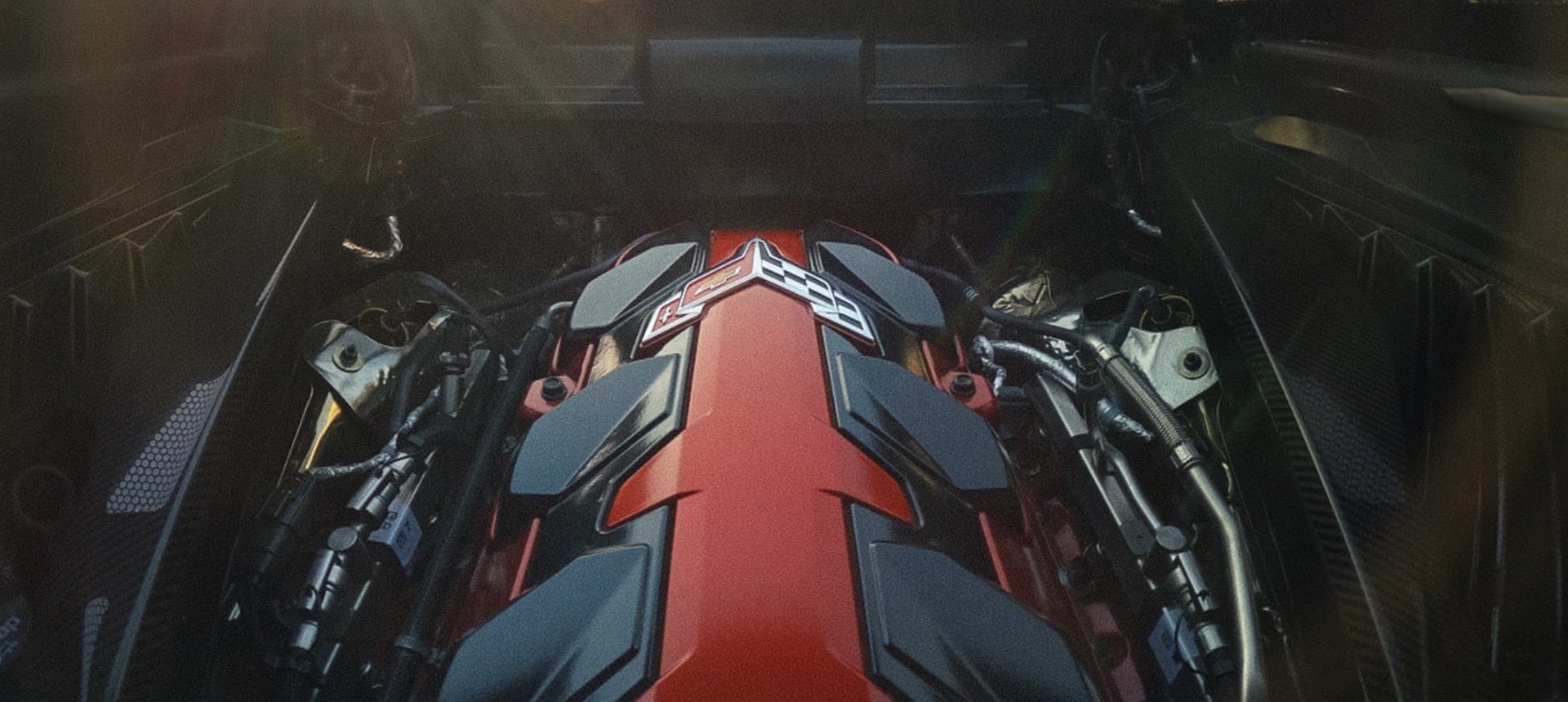2027 Chevrolet Corvette Grand Sport engine bay with red engine cover carrying the Corvette logo and black accents